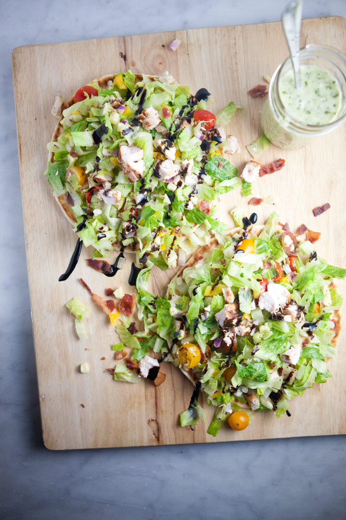 Fresh and Healthy Chopped BLT Salad atop a soft warm greek pita