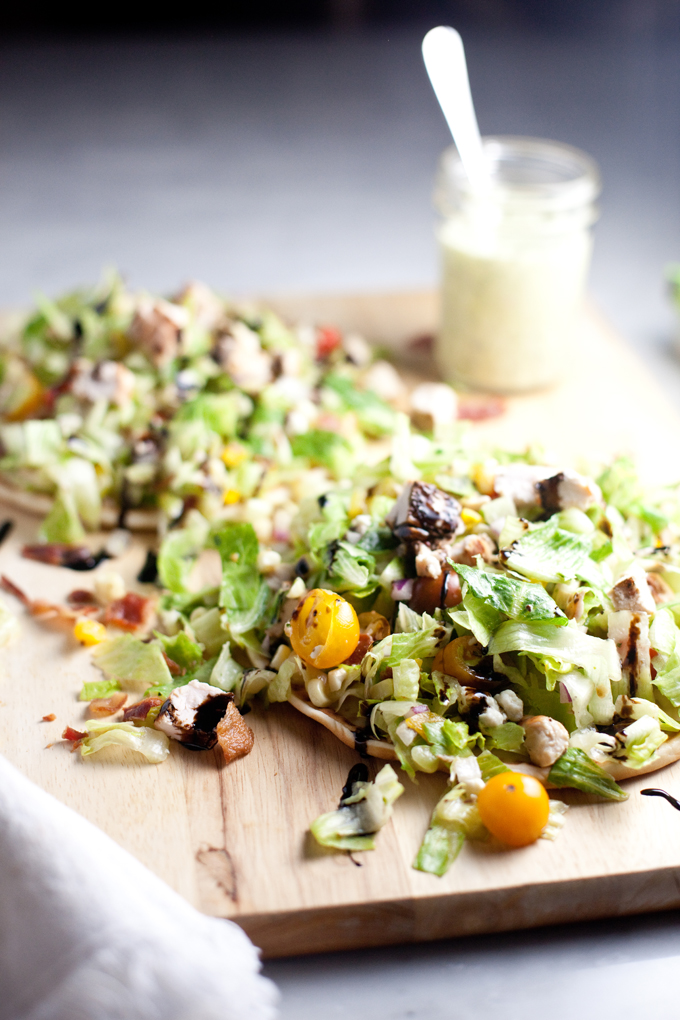 Fresh and Healthy Chopped BLT Salad atop a soft warm greek pita