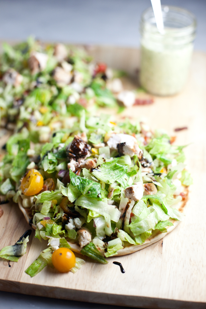 Fresh and Healthy Chopped BLT Salad atop a soft warm greek pita