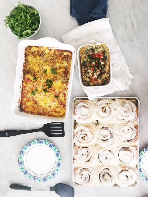 Breakfast casseroles and cinnamon rolls on the table